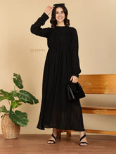 YEZWE black long sleeve Modest Maxi Dress on smiling model with pleated skirt black handbag and sandals